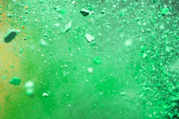 Una raffica di particelle colorate yellowgreen Splash sfondo astratto con messa a fuoco selettiva
