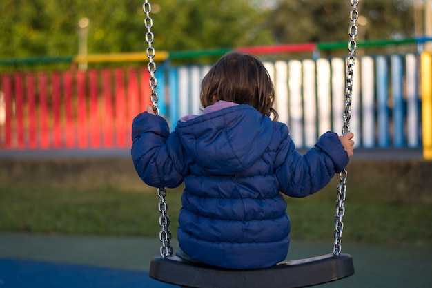 una ragazza che oscilla nel parco