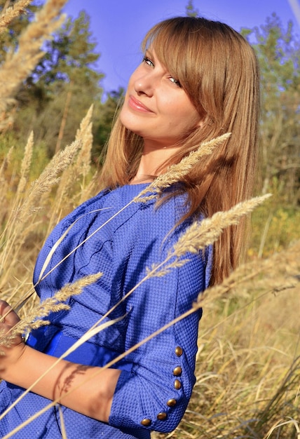Una ragazza in un campo di erba alta