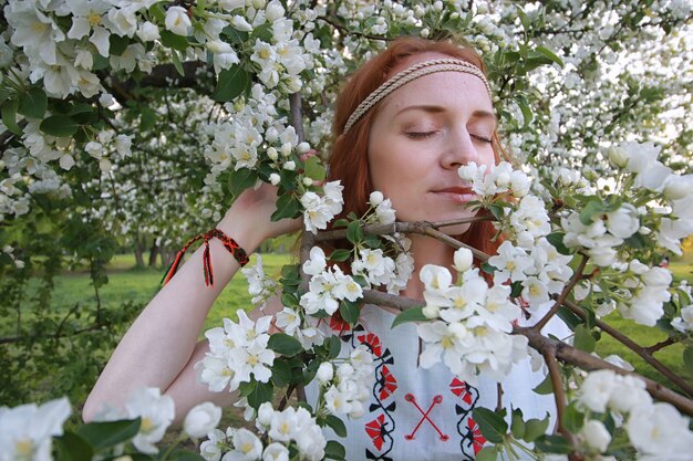 Una ragazza in una passeggiata in un parco d'autunno. Giovane ragazza dai capelli rossi in primavera sulla natura.