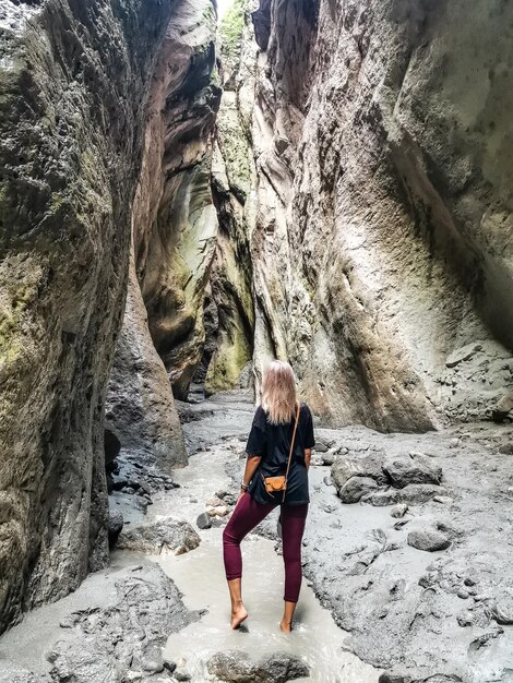 Una ragazza in una stretta gola di montagna Karadakh con la luce del sole in Daghestan Russia giugno 2021