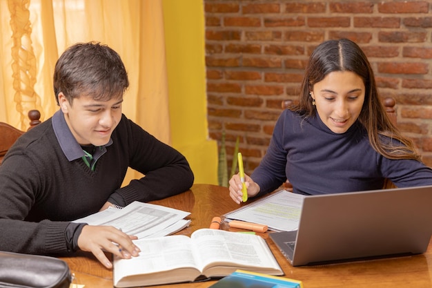 Una ragazza latina che studia accanto a un ragazzo caucasico.