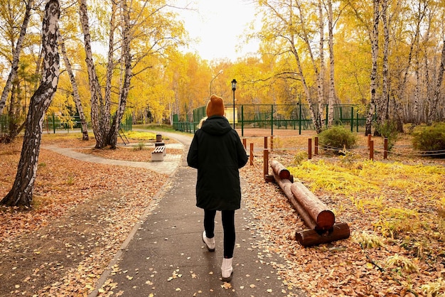 una ragazza va nella foresta autunnale