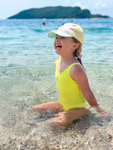 Una ragazzina adorabile sulla spiaggia durante le vacanze estive.