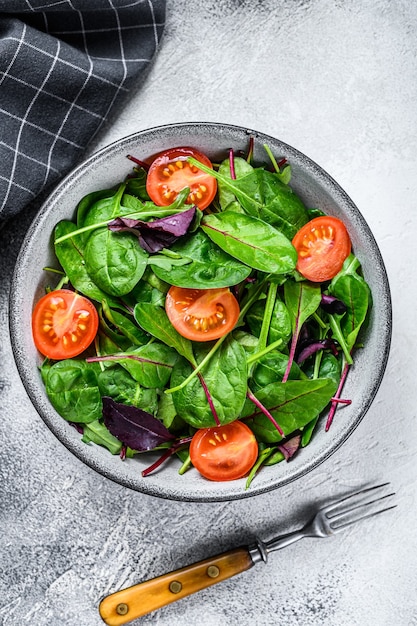 Una sana insalata con foglie di mix mangold, bietole, spinaci e rucola in un'insalatiera