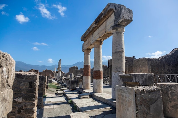 Una scena di strada con colonne e la scritta pompei sulla sinistra