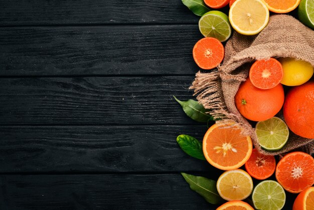 Una serie di agrumi Arancio mandarino pompelmo limone Su uno sfondo di legno Vista dall'alto Copia spazio