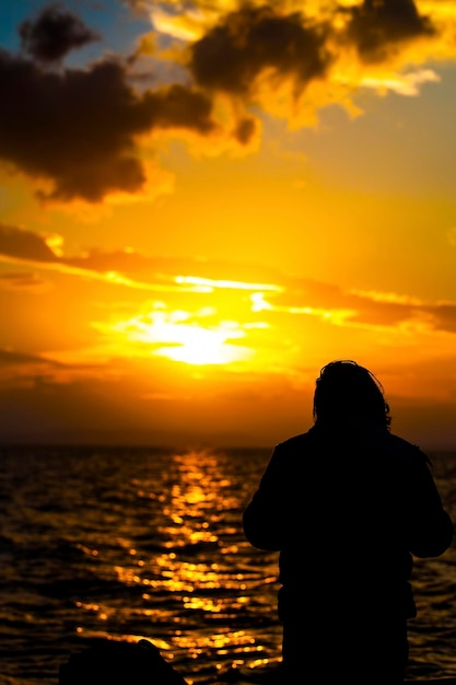 Una silhouette di uomo e la vista del tramonto