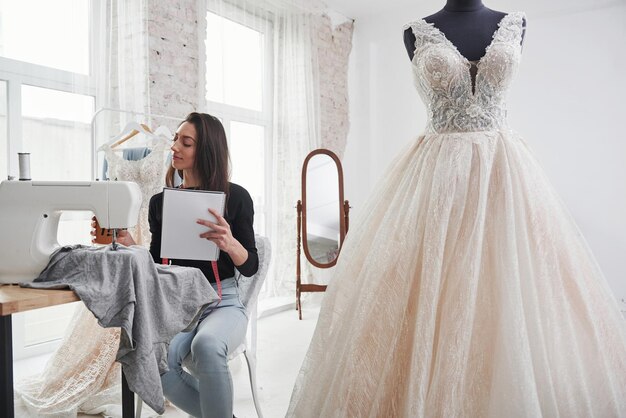 Una stilista femminile lavora ai nuovi vestiti nel laboratorio.