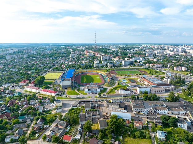 Una vista a volo d'uccello della città Volare un drone sulla città durante il giorno Vista dall'alto di un grande complesso sportivo e di uno stadio di calcio