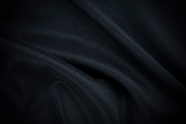 Uno sfondo blu DarkLuxury come tessuto e moda di seta e vestiti texture design con copia spac