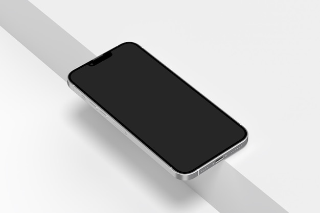 Uno smartphone nero con uno schermo vuoto su una superficie bianca.