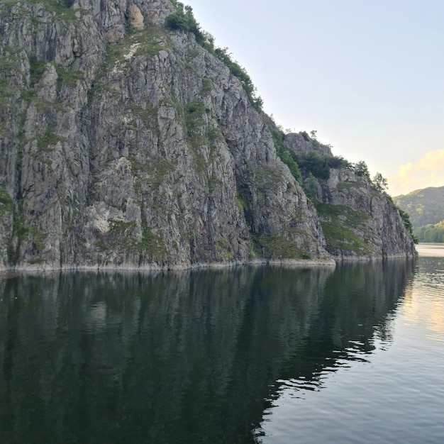 Uno specchio d'acqua con una scogliera rocciosa