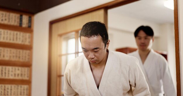 Uomini giapponesi e arco in aikido addestramento per il rispetto disciplina a Tokyo per l'apprendimento di combattimento o classe professionale persona maschile gesto e squadra fitness o lotta istruzione arti marziali o abilità