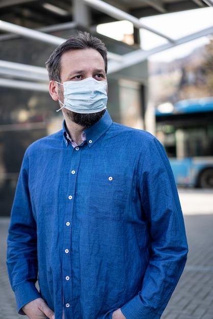 Uomo adulto sulla strada della città con maschera contro il Coronavirus