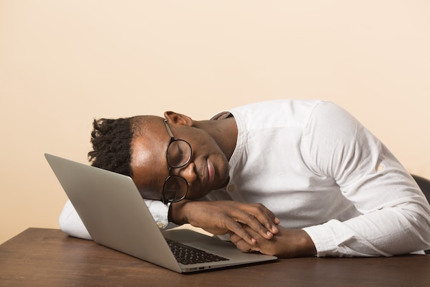 uomo africano con gli occhiali utilizzando laptop