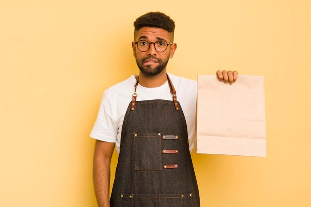 Uomo afro cool che sembra perplesso e confuso fattorino e concetto di fast food