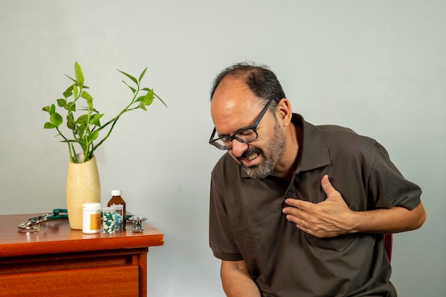 Uomo anziano con dolore alla spalla. Il signore di mezza età soffre orribilmente. Dolore al collo e alla spalla che soffre di lesioni al collo e alla spalla, persona con problemi di salute