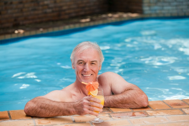 Uomo anziano nella sua piscina