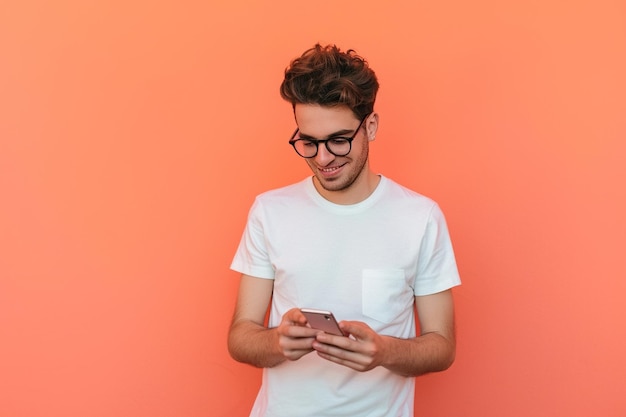 Uomo casuale sullo sfondo pesca usando uno smartphone.