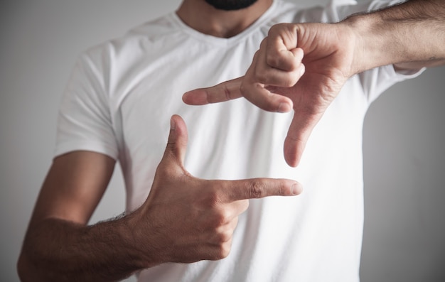 Uomo caucasico che fa cornice con le mani.