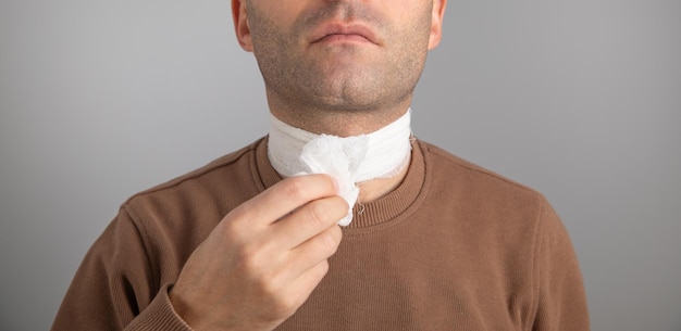 Uomo caucasico con una benda sul collo