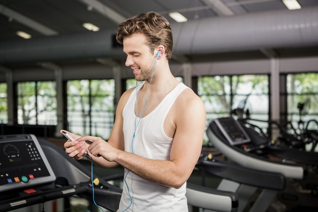 Uomo che ascolta la musica sul tapis roulant