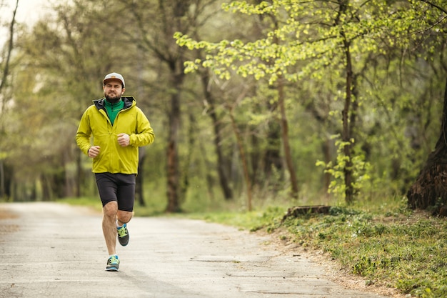 Uomo che corre al mattino in un parco