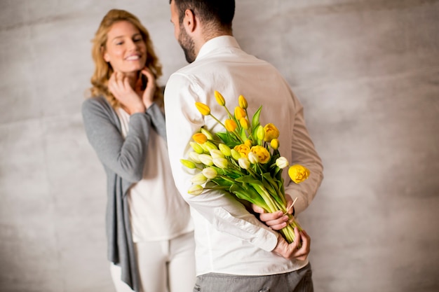 Uomo che dà il mazzo di tulipani gialli alla sua ragazza