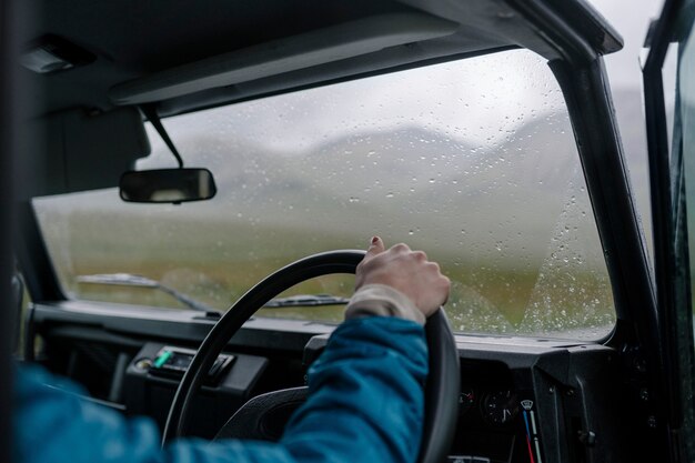 Uomo che guida un vecchio SUV nelle Highlands