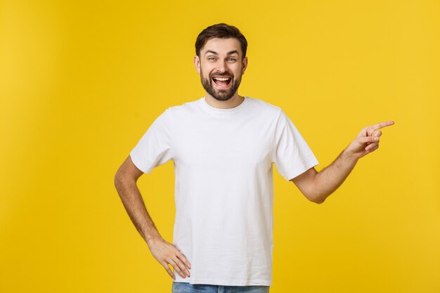 Uomo che indica mostrando lo spazio della copia isolato. Giovane caucasico bello casuale.