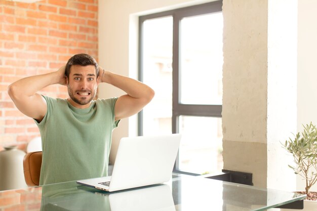 uomo che si sente stressato, preoccupato, ansioso o spaventato, con le mani sulla testa, in preda al panico per l'errore