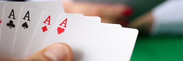 Uomo che tiene la mano di poker vincente al primo piano del tavolo. Concetto di dipendenza dal gioco d'azzardo