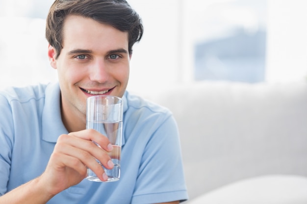 Uomo che tiene un bicchiere d&#39;acqua