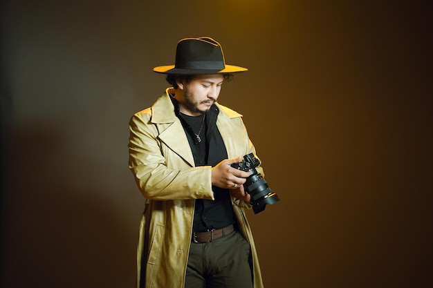 uomo con cappello in possesso di una macchina fotografica