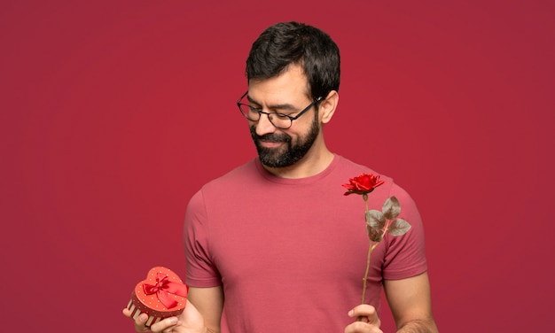 Uomo con la barba nel giorno di San Valentino su sfondo rosso