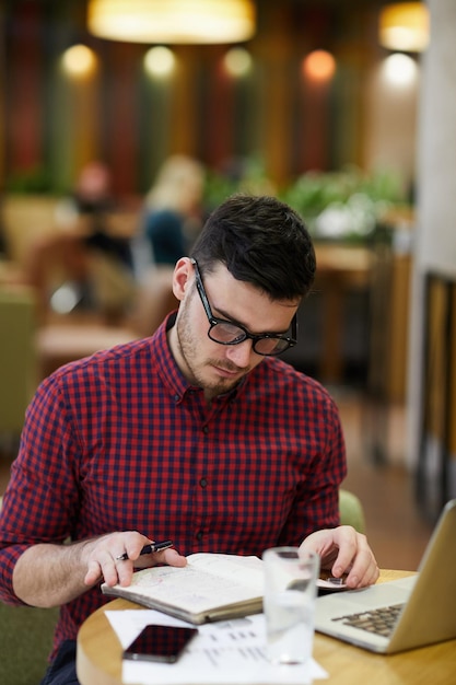 Uomo concentrato che analizza le note nel diario