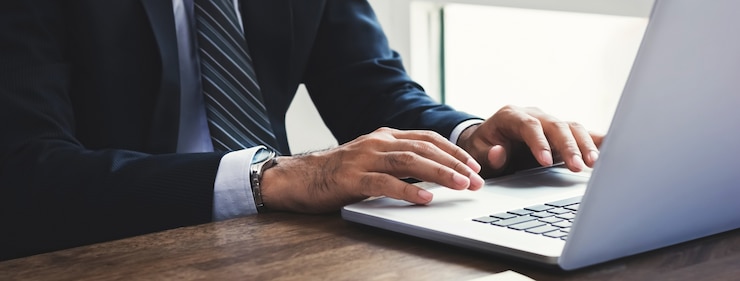 Foto uomo d&#39;affari che lavora al computer portatile in ufficio