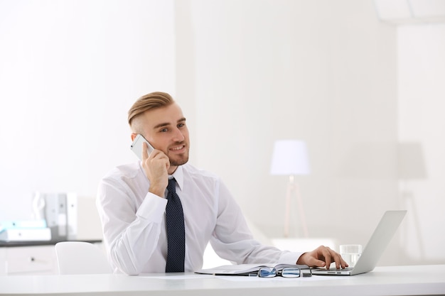 Uomo d'affari che lavora con il computer portatile in ufficio