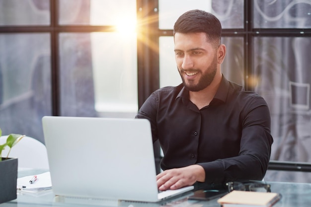 Uomo d'affari che lavora su un computer portatile in ufficio