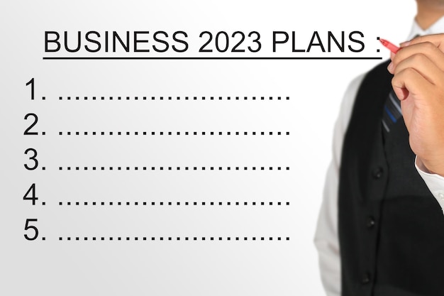 uomo d'affari che scrive business 2023 pianifica lo sfondo