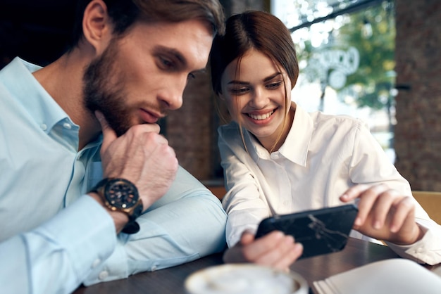 Uomo d'affari e donna in un caffè comunicazione lavoro telefonico foto di alta qualità