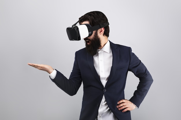 uomo d'affari sorpreso in occhiali VR guardando sulla mano vuota, concetto di realtà virtuale, immagine mock-up