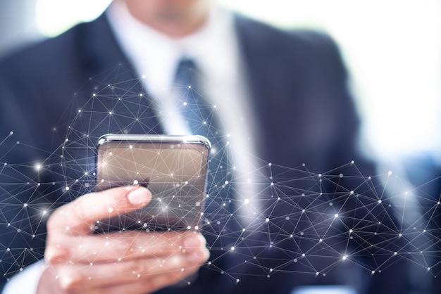 Uomo d'affari utilizza lo smartphone con la connessione alla rete informatica globale