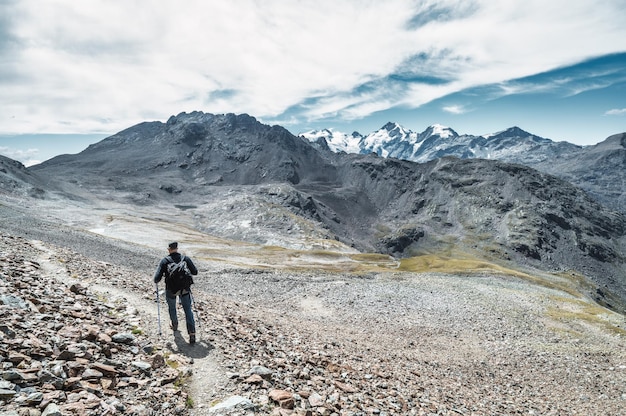 Uomo da solo sul sentiero di alta montagna