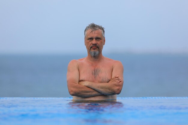 uomo dai capelli grigi in piscina