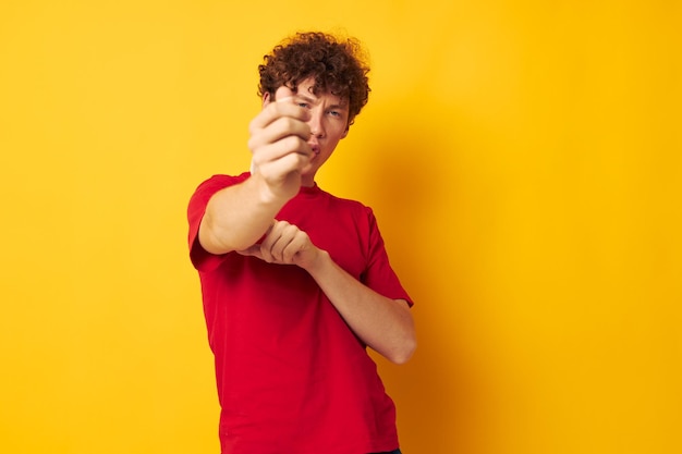 Uomo dai capelli rossi in maglietta rossa su sfondo giallo