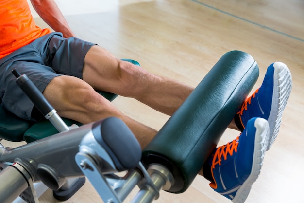 Uomo di esercizio di estensione della gamba in allenamento in palestra