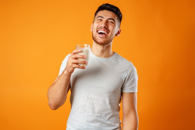 Uomo di razza mista sorridente felice che tiene il latte