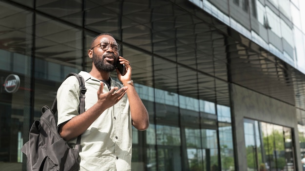 Uomo di tiro medio che parla al telefono